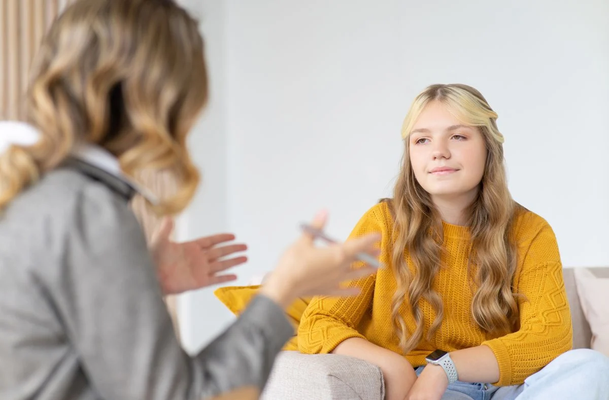 Compassionate health care providers helping a teenager Adolescent participating in a counseling session in Scotch Plains, NJ, using mindfulness techniques to manage mental health problems and improve emotional regulation related to mood disorders.